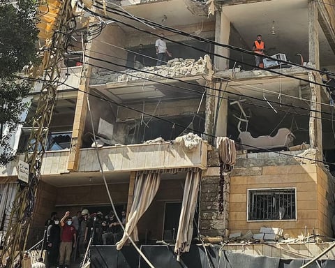 First responders inspect damage at apartment building hit by Israeli airstrike in Beirut Dahiyeh suburb June 2026