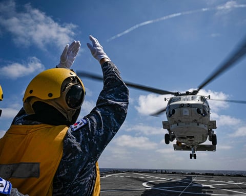 Japan Maritime Self-Defense Force helicopter lands on South Korean Navy amphibious ship during SAREX drill southeast of Jeju Island June 2026