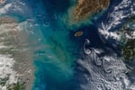 NASA Terra MODIS image of Jeju Island Korea Strait February 19 2026 with sediment plume from Chinese coast and cloud vortices