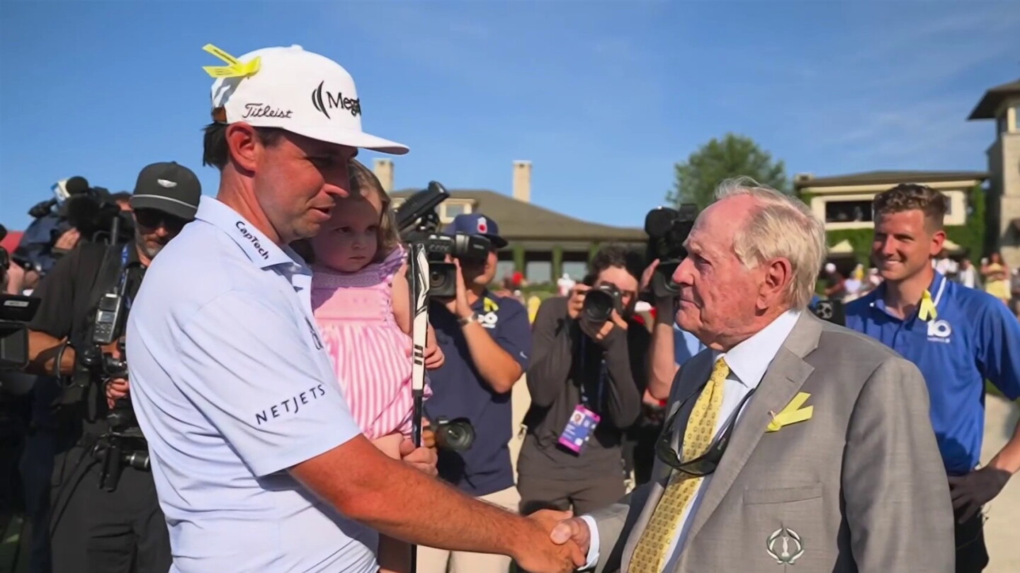 J.T. Poston holds his daughter Scottie while Jack Nicklaus congratulates him after winning the 2026 Memorial Tournament