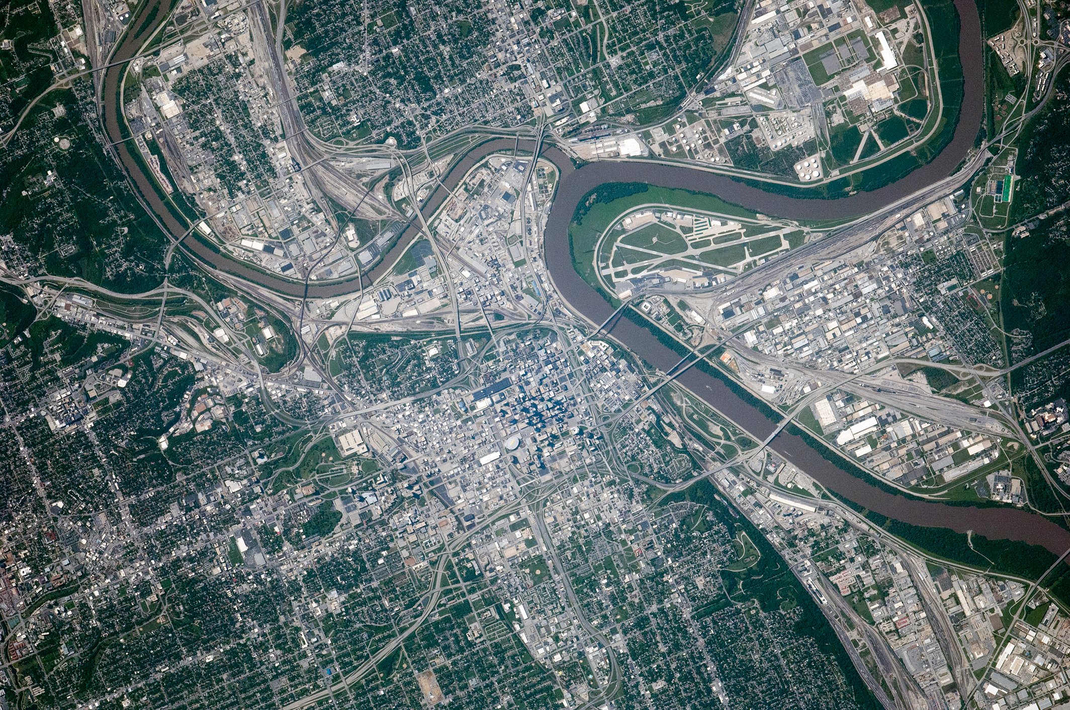 NASA astronaut photograph from the International Space Station of the Kansas City metropolitan area showing the Missouri and Kansas rivers meeting with the Kansas City Missouri urban grid on one side and Kansas City Kansas on the other