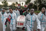 Activists carry a mock coffin during a protest against the US-built Ebola quarantine centre in Kenya