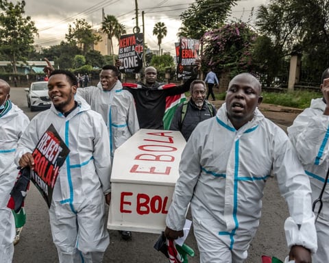 Activists carry a mock coffin during a protest against the US-built Ebola quarantine centre in Kenya