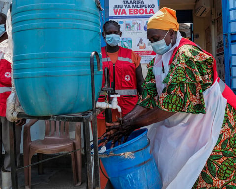 Health worker washes hands at Mpondwe border crossing between Uganda and DRC during 2026 Ebola outbreak