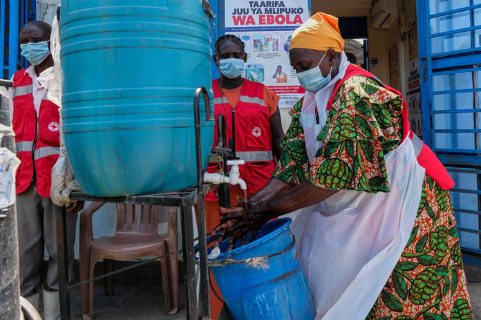 Health worker washes hands at Mpondwe border crossing between Uganda and DRC during 2026 Ebola outbreak