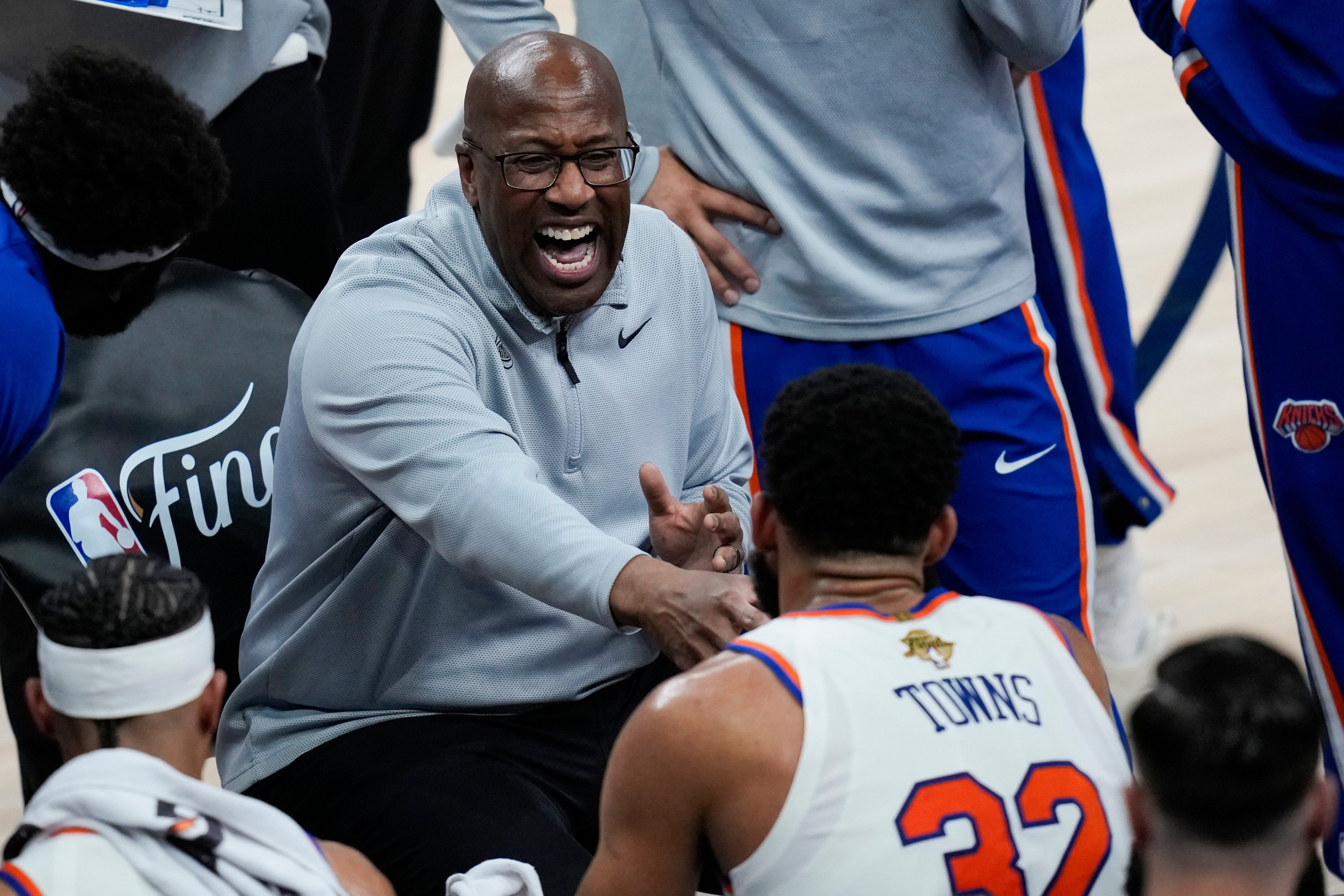 New York Knicks head coach Mike Brown laughs with center Karl-Anthony Towns during a timeout in Game 1 of the 2026 NBA Finals