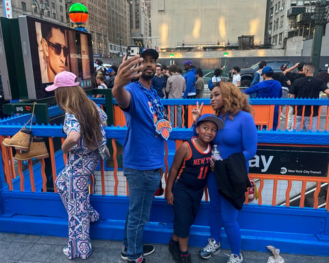 Knicks fans celebrate at a decorated New York City subway entrance during the 2026 NBA Finals