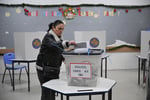 A voter casts a ballot at a polling station in Pristina during Kosovo's snap election