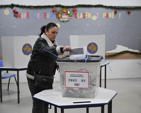 A voter casts a ballot at a polling station in Pristina during Kosovo's snap election