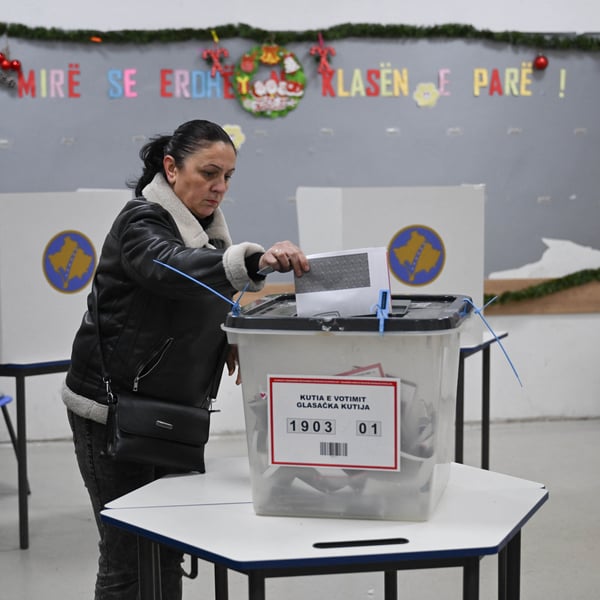 A voter casts a ballot at a polling station in Pristina during Kosovo's snap election
