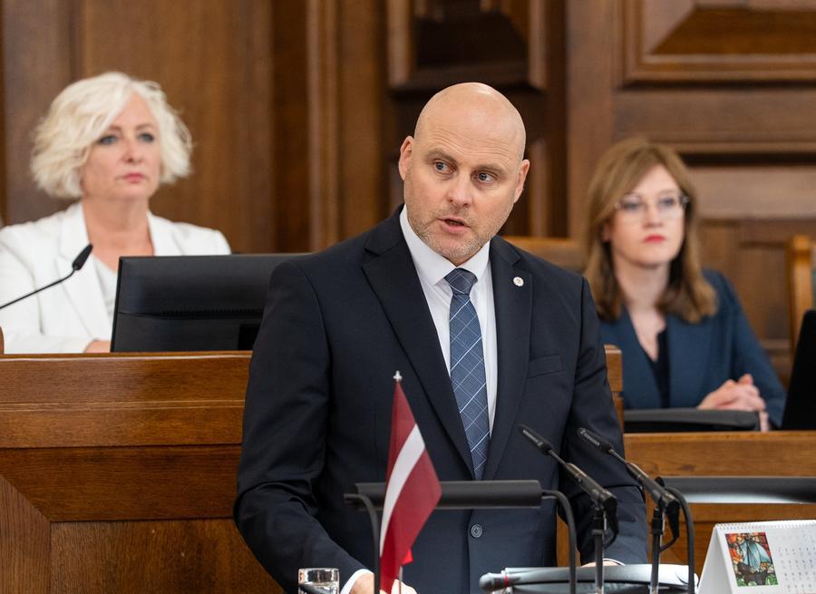 Andris Kulbergs delivers speech at Latvian parliament Saeima before government confidence vote Riga May 2026