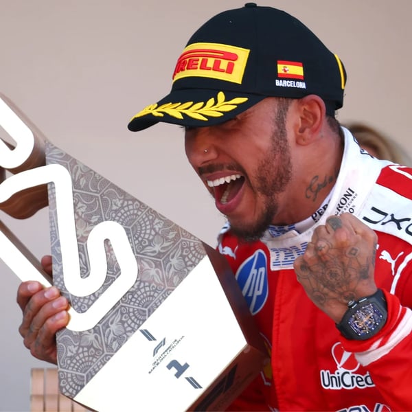 Lewis Hamilton crosses the finish line in Ferrari red at the 2026 Barcelona-Catalunya Grand Prix for his maiden Ferrari Formula One win