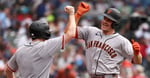 Matt Chapman of San Francisco Giants celebrates with bat boy after hitting three-run home run against Chicago Cubs at Wrigley Field