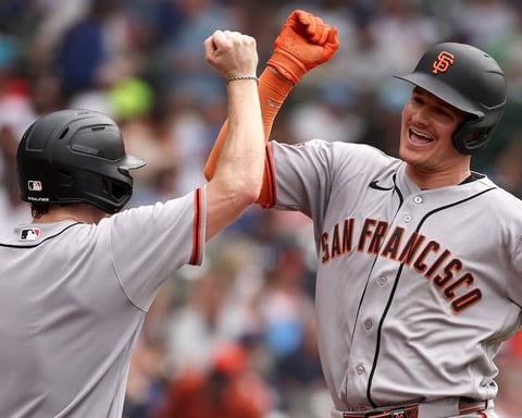 Matt Chapman of San Francisco Giants celebrates with bat boy after hitting three-run home run against Chicago Cubs at Wrigley Field