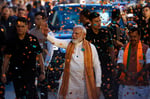Prime Minister Narendra Modi greets supporters at BJP headquarters in New Delhi after the party's state election wins