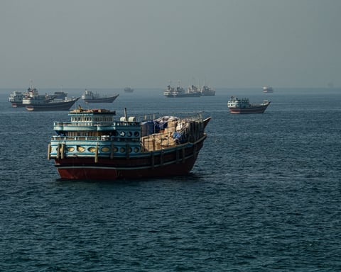 Cargo ships pass through the Strait of Hormuz as Iran-US tensions reshape Gulf shipping routes