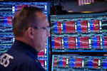 Trader on floor of New York Stock Exchange as Nasdaq plunges 4 percent on June 5 2026 after jobs report fuels Fed rate hike fears
