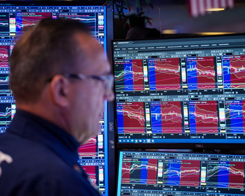 Trader on floor of New York Stock Exchange as Nasdaq plunges 4 percent on June 5 2026 after jobs report fuels Fed rate hike fears
