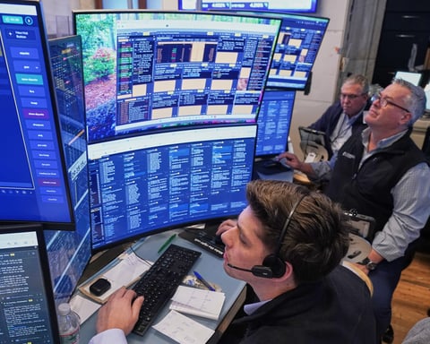 Traders work on the floor of the New York Stock Exchange in New York City