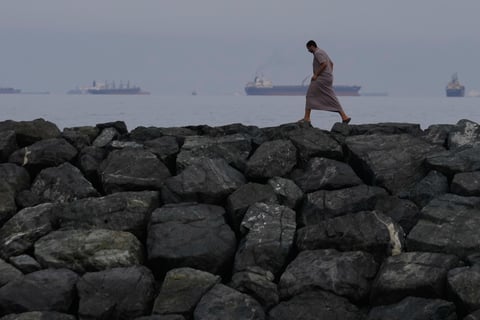 Oil tankers and cargo ships line up in the Strait of Hormuz as seen from Khor Fakkan UAE amid Iran blockade 2026