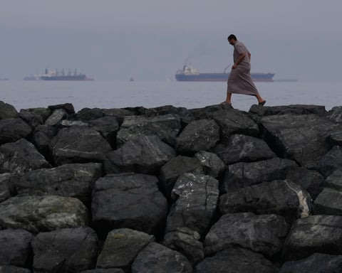 Oil tankers and cargo ships line up in the Strait of Hormuz as seen from Khor Fakkan UAE amid Iran blockade 2026