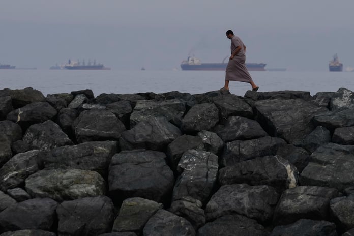 Oil tankers and cargo ships line up in the Strait of Hormuz as seen from Khor Fakkan UAE amid Iran blockade 2026
