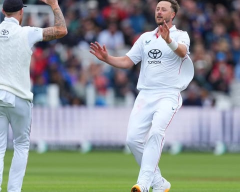 England seamer Ollie Robinson celebrates with Ben Stokes after dismissing Rachin Ravindra at Lord's on day three of the first Test against New Zealand, June 6, 2026