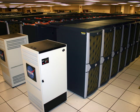 Rows of supercomputer server racks at NASA's Ames Research Center, representing modern high-performance computing infrastructure