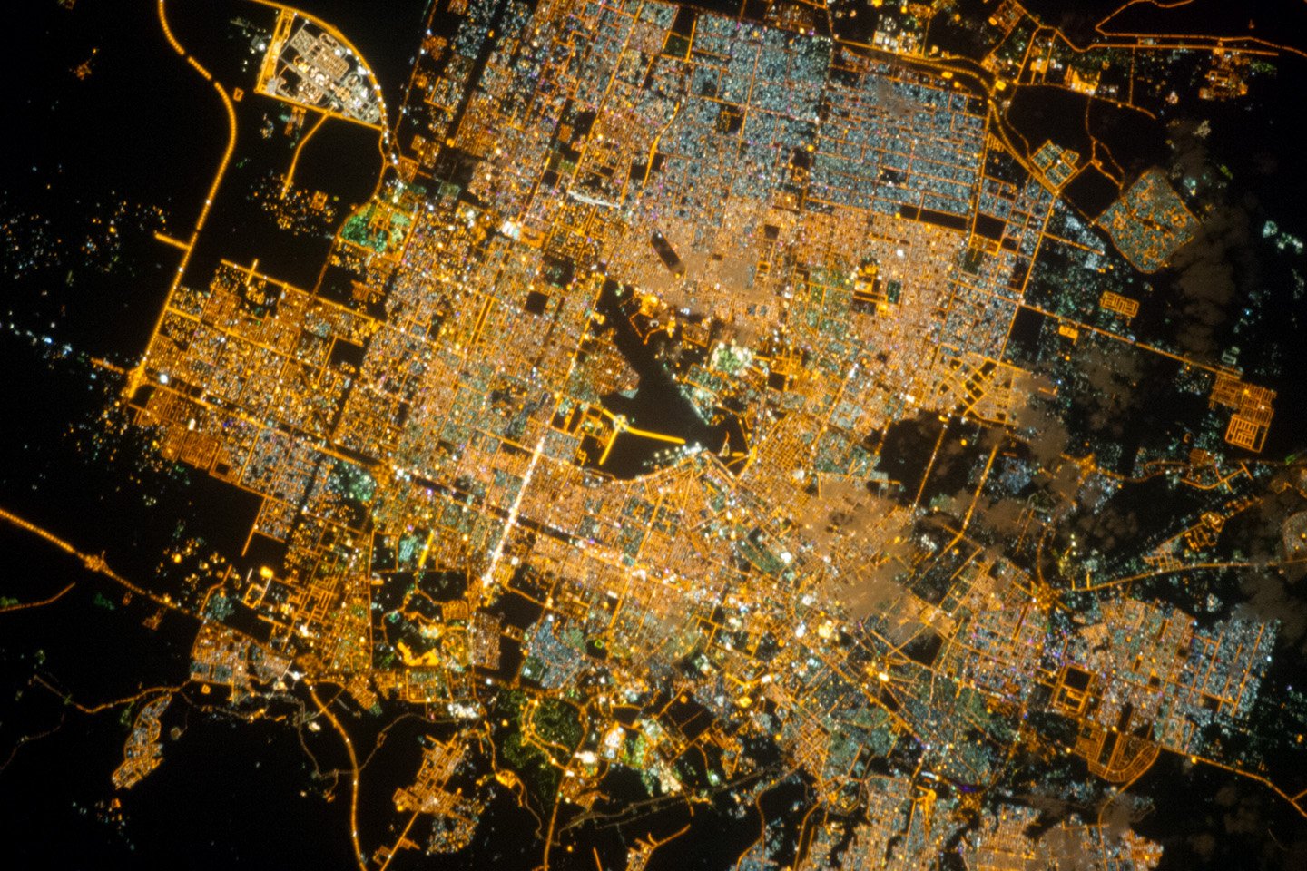 NASA astronaut photograph of Riyadh Saudi Arabia at night from the International Space Station showing the brightly illuminated capital radiating along ring roads from a glowing central business district