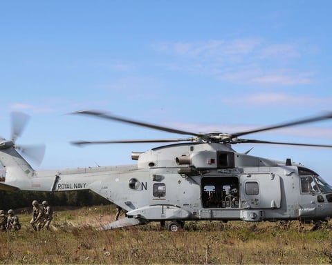 A Royal Navy Merlin Mk4 helicopter in flight, operated by the Fleet Air Arm Commando Helicopter Force
