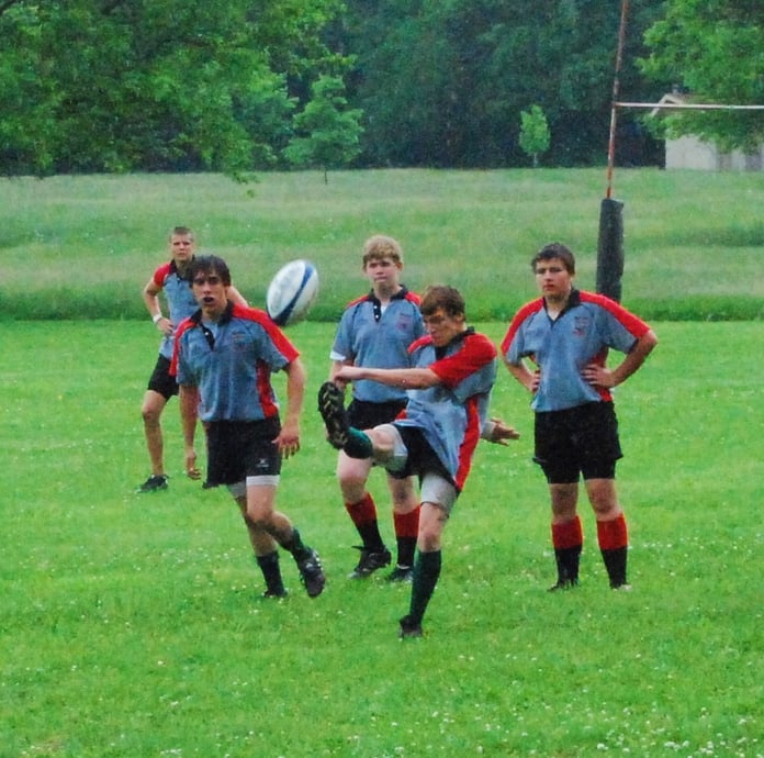 A rugby union ball being kicked on a field, illustrating a rugby story