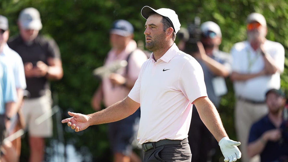 Scottie Scheffler reacts to his tee shot finding water on the par-3 16th hole at Muirfield Village during the 2026 Memorial Tournament