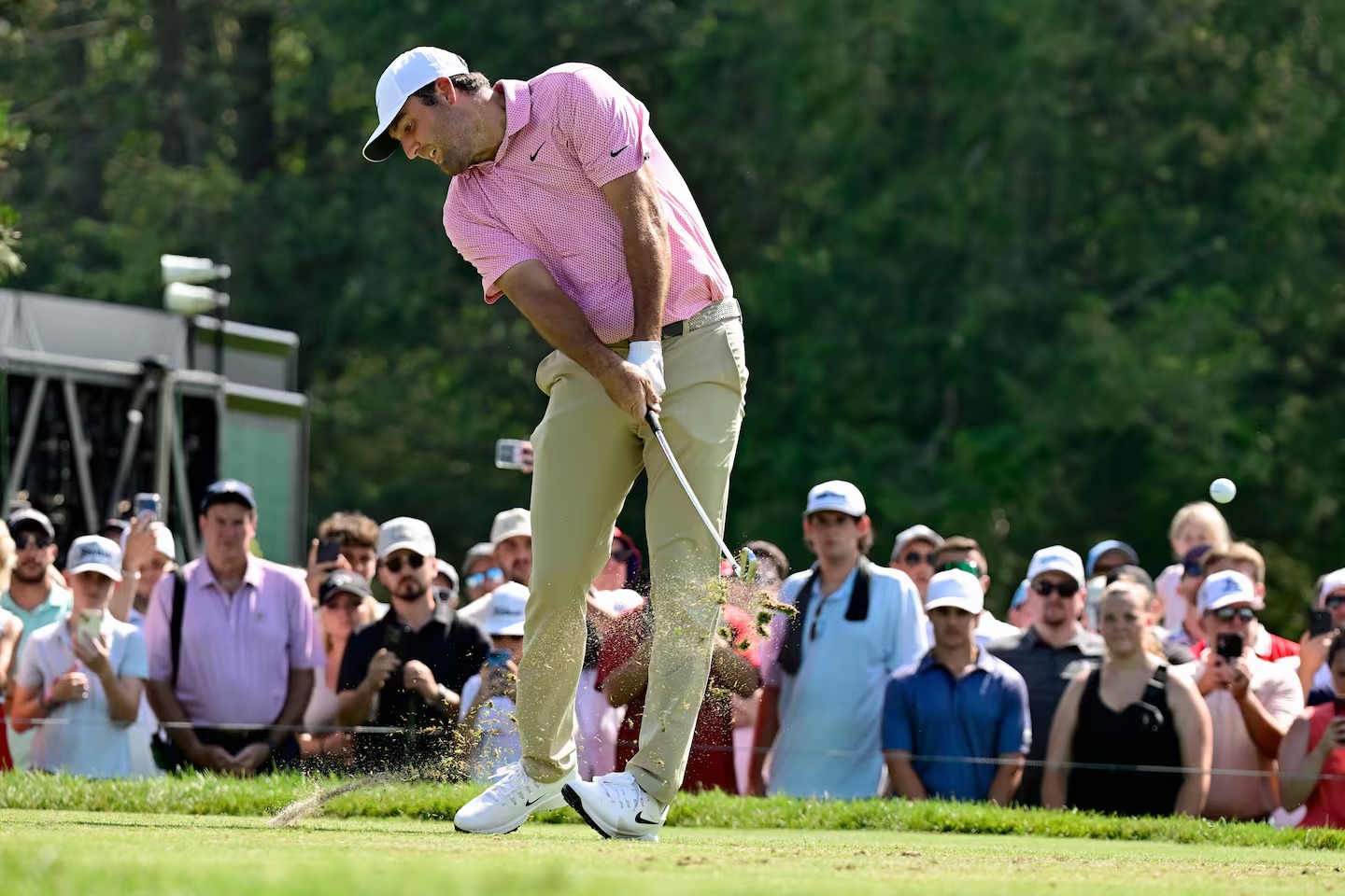 Scottie Scheffler reacts after holing par putt on 18th hole to force Monday sudden-death playoff at 2026 Travelers Championship TPC River Highlands