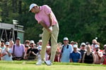 Scottie Scheffler reacts after holing par putt on 18th hole to force Monday sudden-death playoff at 2026 Travelers Championship TPC River Highlands