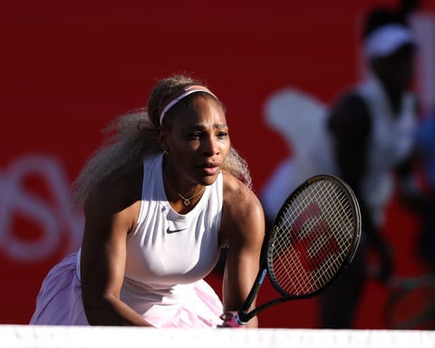 Serena Williams serves during her winning doubles comeback match with Victoria Mboko at Queen's Club in London