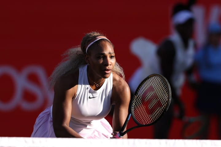 Serena Williams serves during her winning doubles comeback match with Victoria Mboko at Queen's Club in London