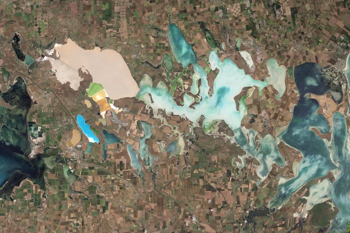 NASA Landsat 5 Thematic Mapper natural-color satellite image of the Sivash salt lagoons between the Black Sea and the Sea of Azov showing the narrow Perekop Isthmus that connects Crimea to mainland Ukraine and the Armiansk bridge corridor