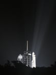 A SpaceX Falcon Heavy rocket lifts off at night from Kennedy Space Center