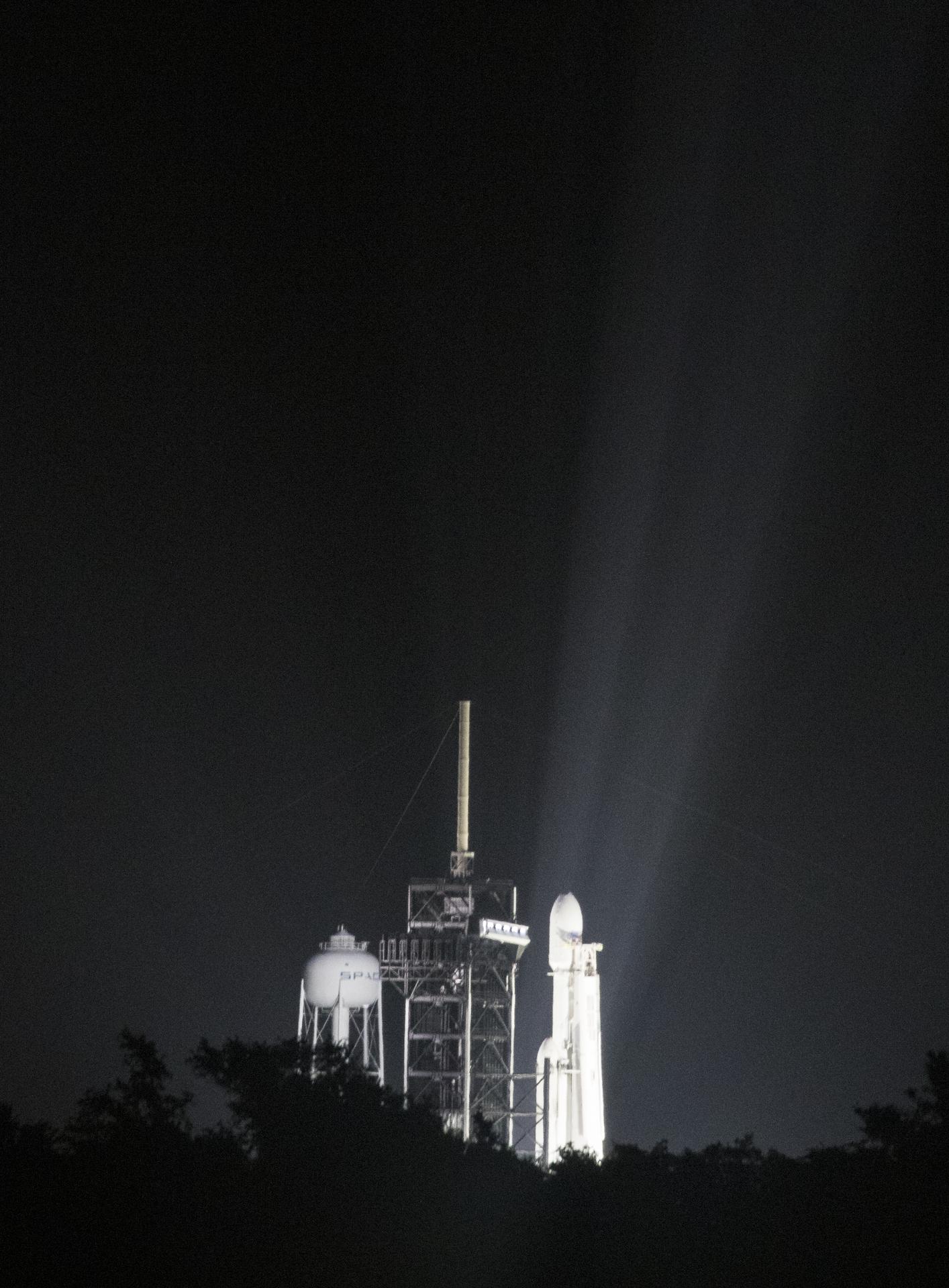 A SpaceX Falcon Heavy rocket lifts off at night from Kennedy Space Center