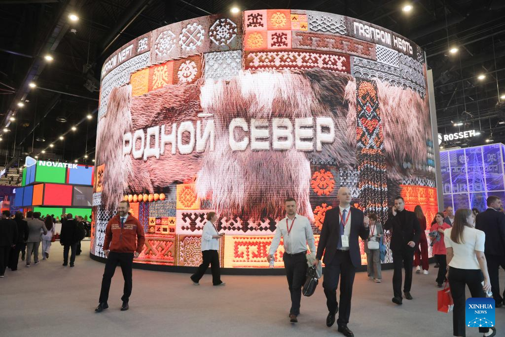 Visitors inside the SPIEF 2026 exhibition hall in St. Petersburg as smoke from the Ukrainian drone strike hung over the port on June 3 2026