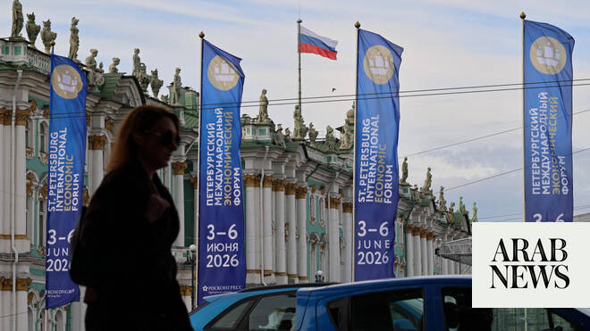 SPIEF 2026 flags outside the State Hermitage Museum in St. Petersburg with smoke from Ukrainian drone attack in distance