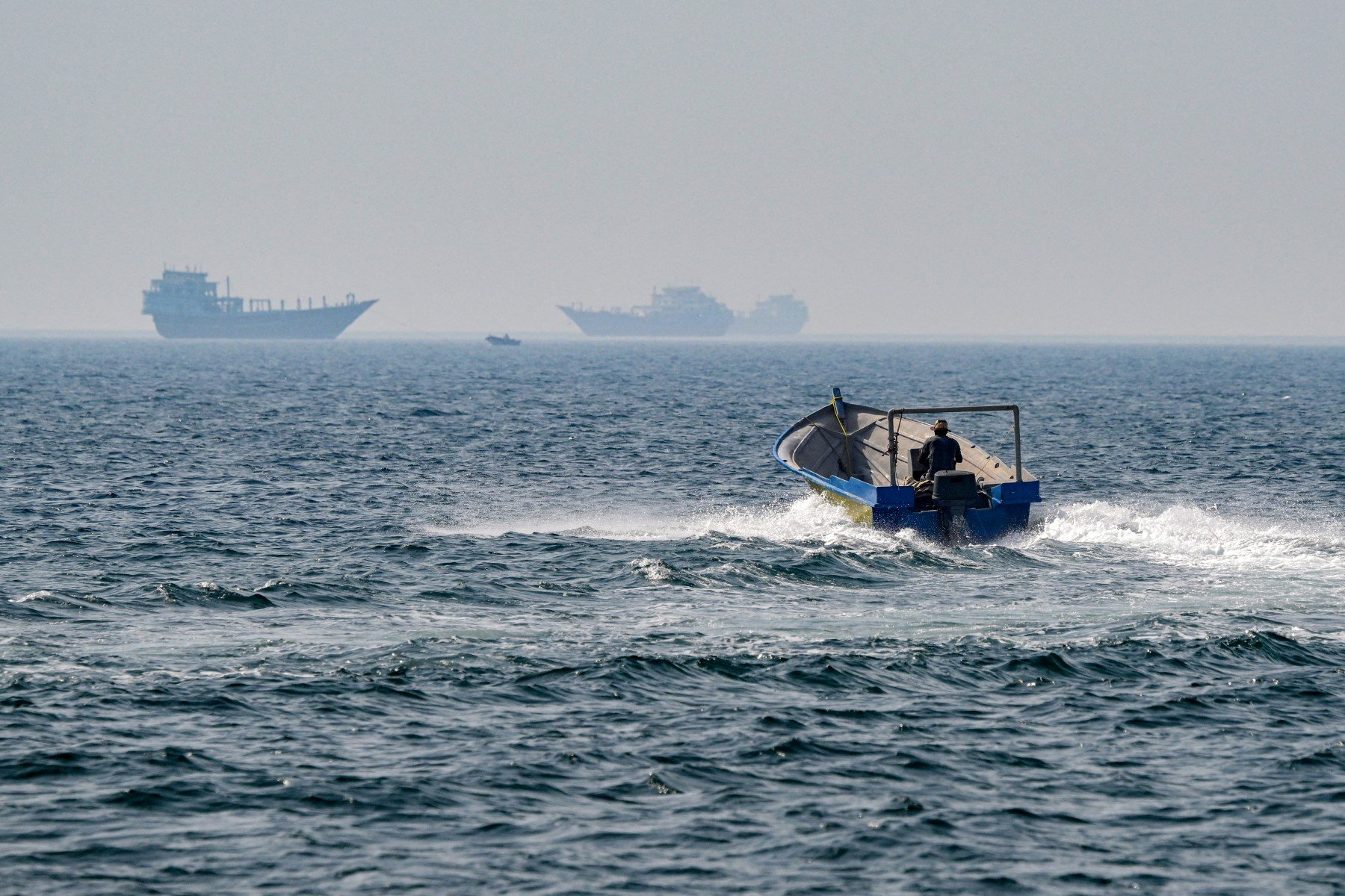 A boat sails in the waters of the Strait of Hormuz off Khasab in Oman's Musandam peninsula