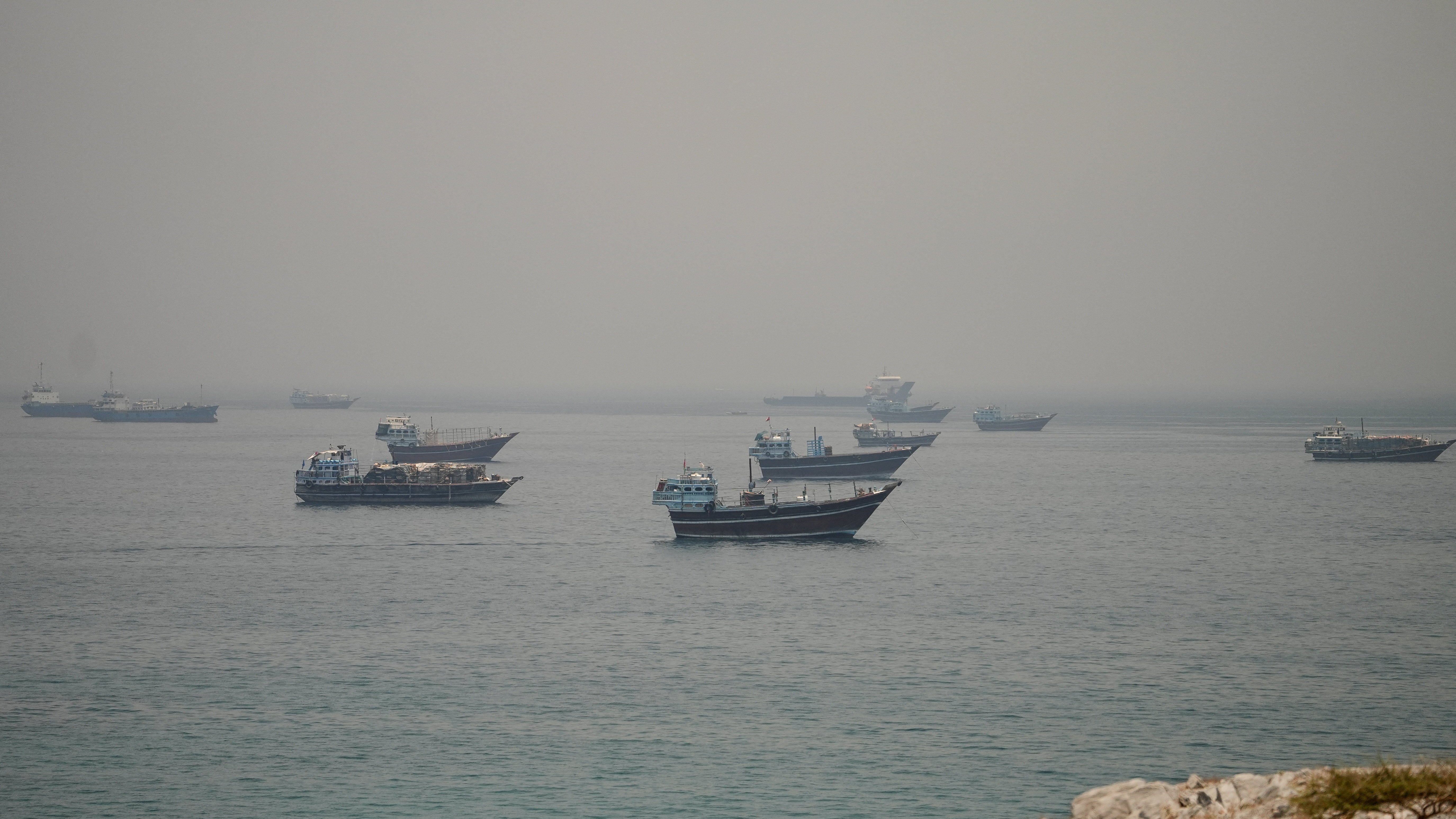 Vessels anchored in the Strait of Hormuz seen from Oman as Pakistan confirms the US-Iran peace deal text is final