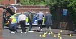 PSNI forensic officers investigate the scene of the stabbing attack on Kinnaird Avenue in north Belfast, Northern Ireland