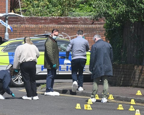 PSNI forensic officers investigate the scene of the stabbing attack on Kinnaird Avenue in north Belfast, Northern Ireland