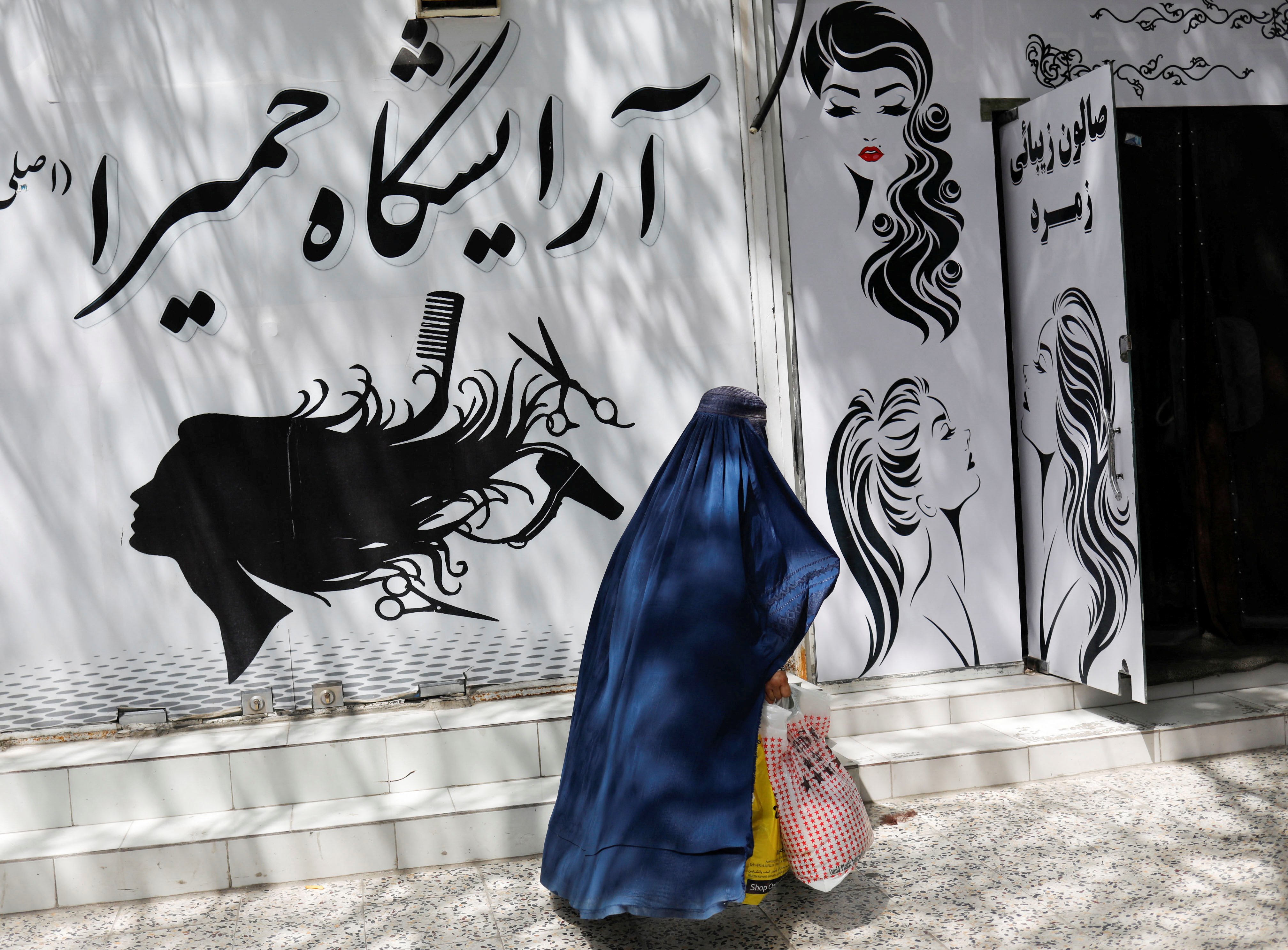 Afghan women in Herat under Taliban morality enforcement of mandatory hijab and burqa rules