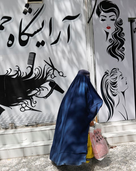 Afghan women in Herat under Taliban morality enforcement of mandatory hijab and burqa rules