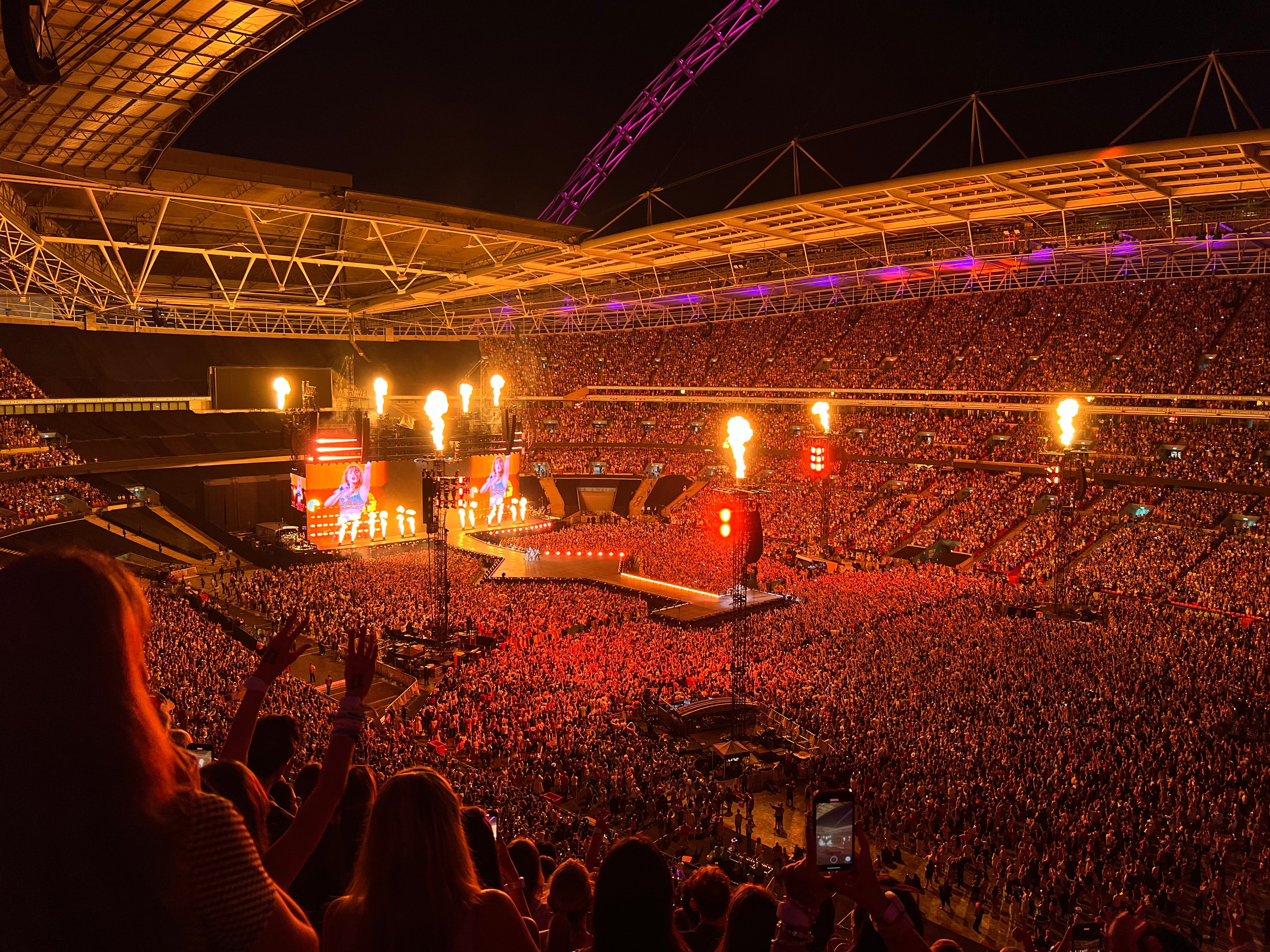 Taylor Swift performing on the Eras Tour in London in August 2024, before her quiet country return