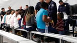 Migrants going through an asylum processing area