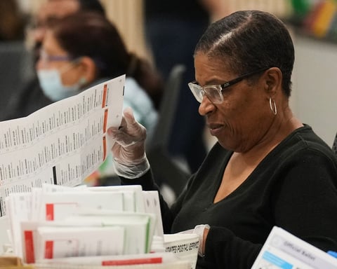 Election workers inspect mail-in ballots at the Los Angeles County Ballot Processing Center during California primary 2026